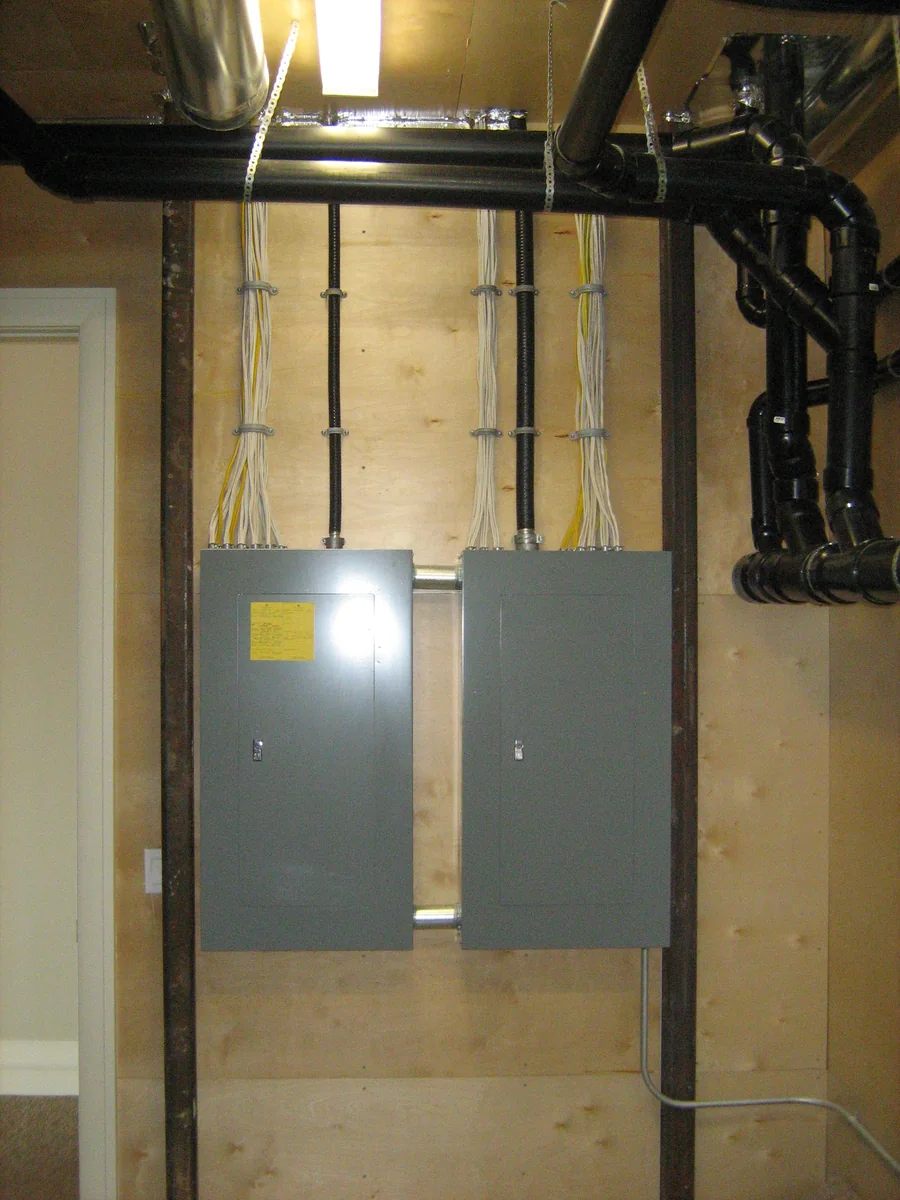 Electrical distribution panels and conduit in an unfinished utility area
