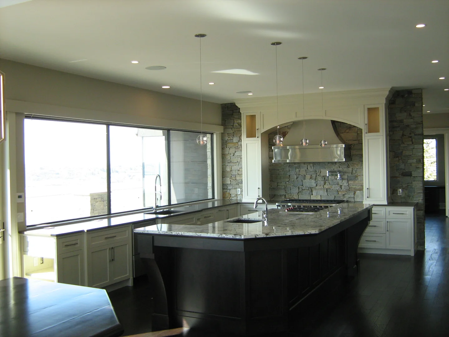 Residential kitchen with recessed ceiling lights and pendant fixtures